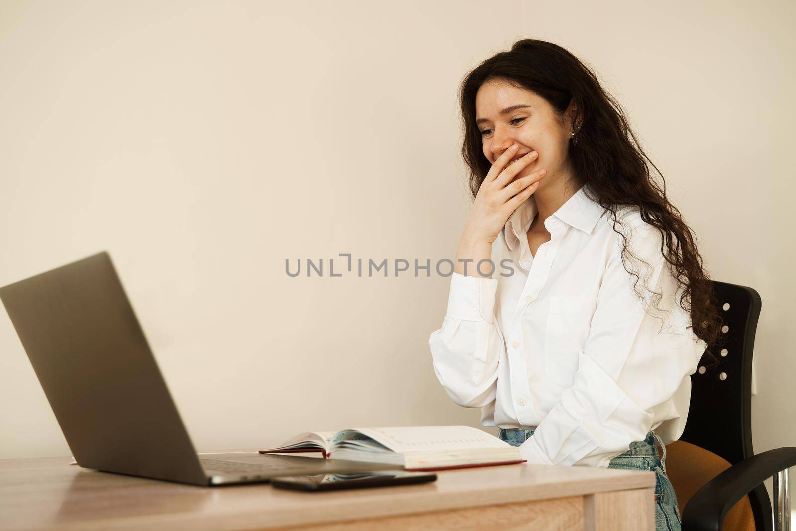 Surprised girl enjoying friendly video call on laptop computer using web camera for communicating. Video communication with colleagues at home