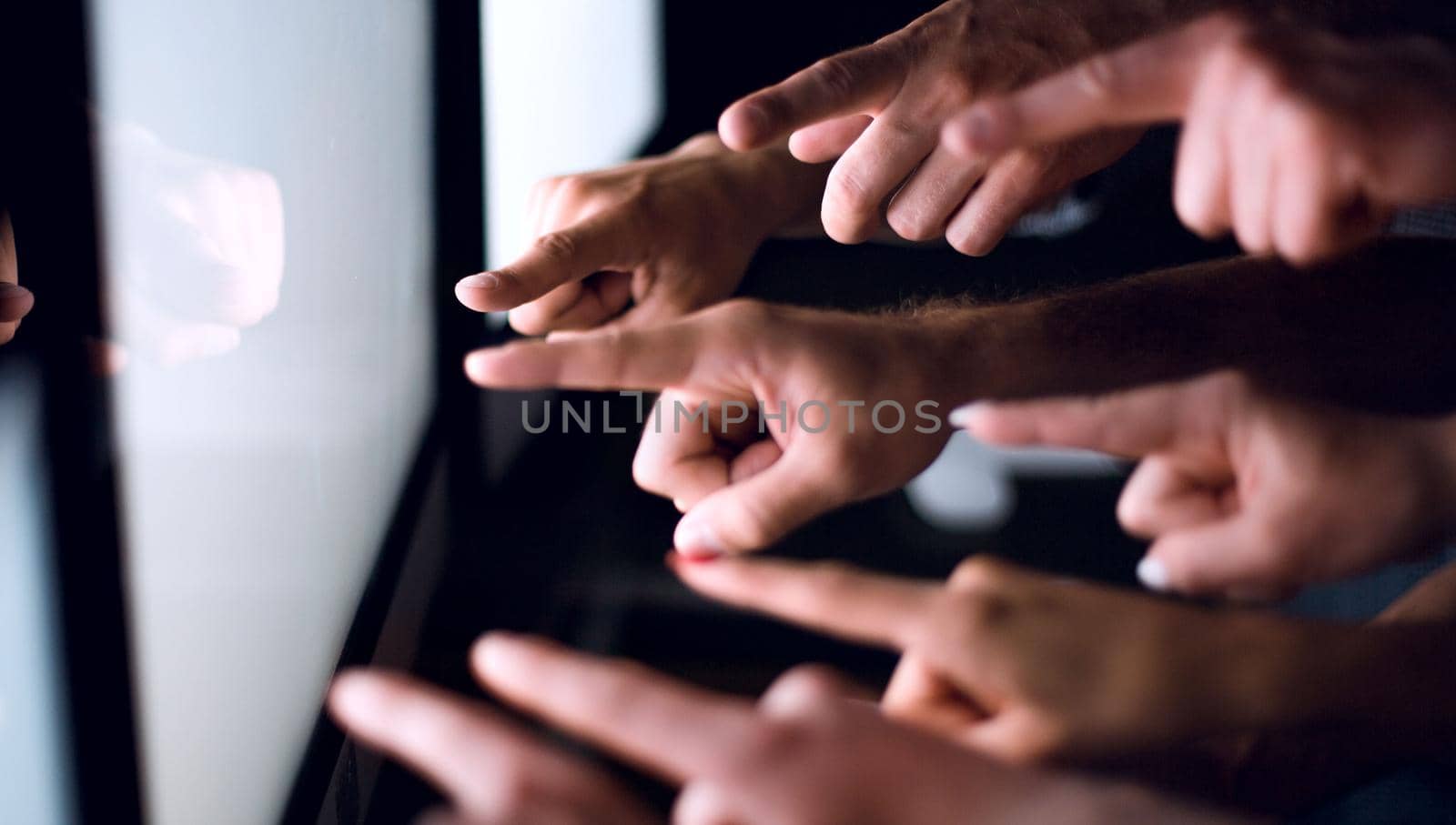 business team pointing their fingers at the computer screen .photo with copy space