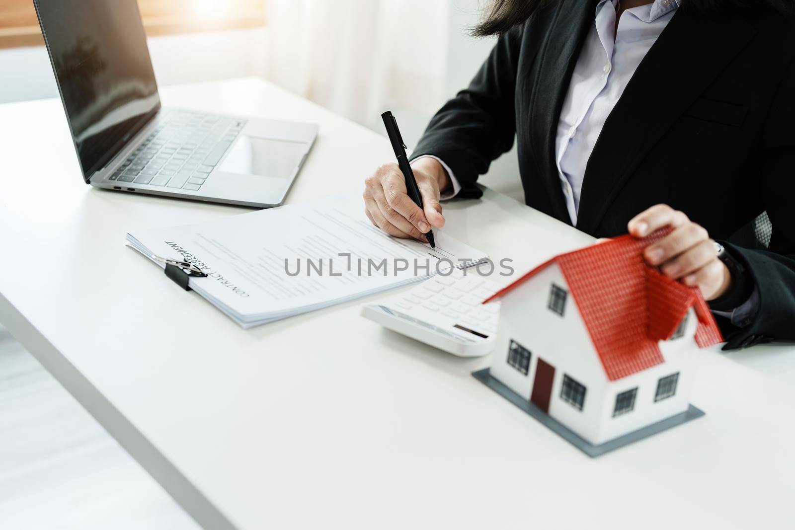 Law, agreement, contract, mortgage, woman holding a pen, reading the contract document in buying a house to see the interest rate and asking for the limit to assess the risk before buying a house.