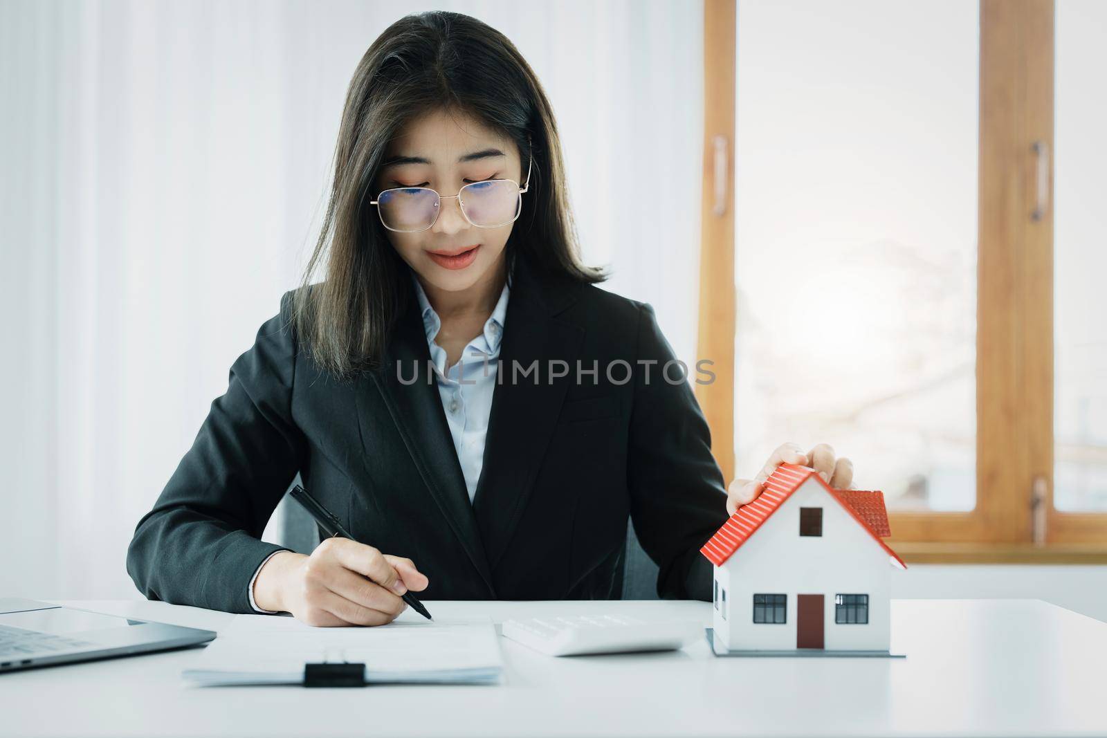 Law, agreement, contract, mortgage, woman holding a pen, reading the contract document in buying a house to see the interest rate and asking for the limit to assess the risk before buying a house.