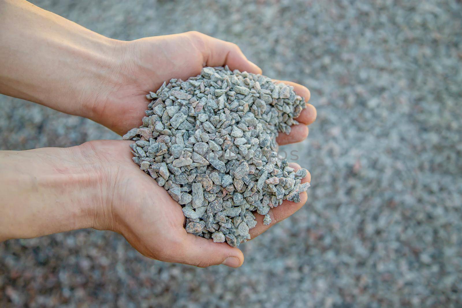 Man holding small rubble in his hands