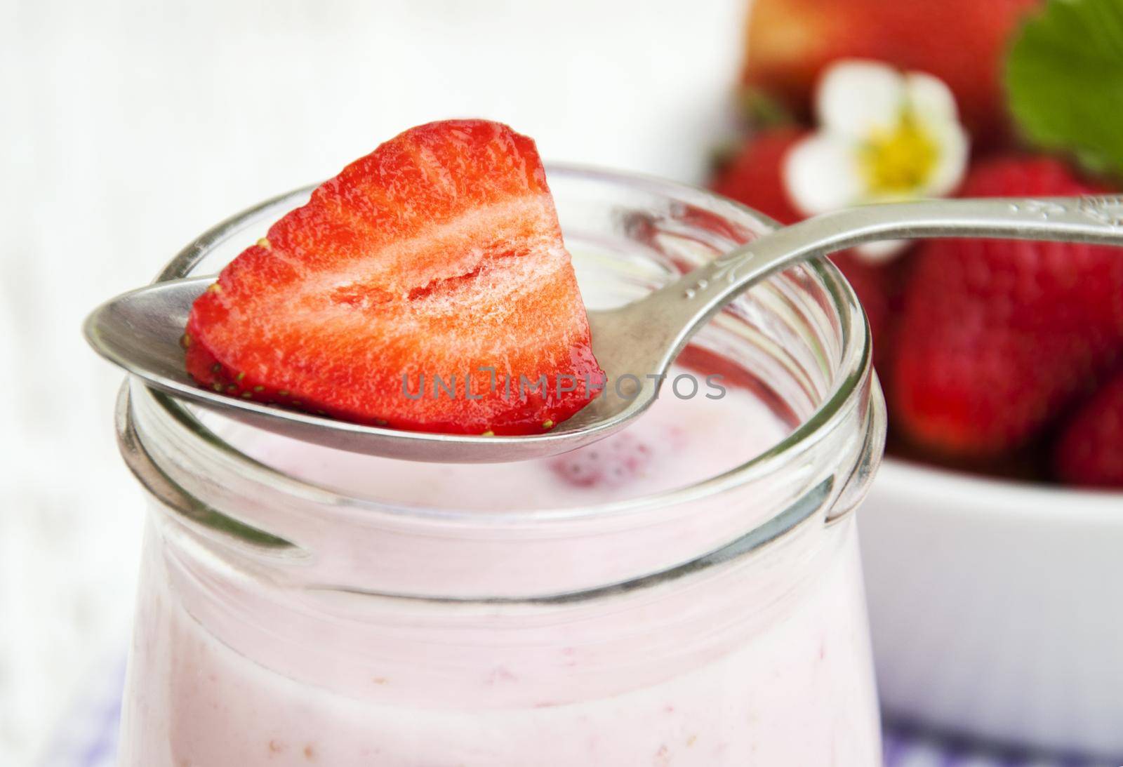 Strawberry yogurt with fresh strawberries on a wooden background