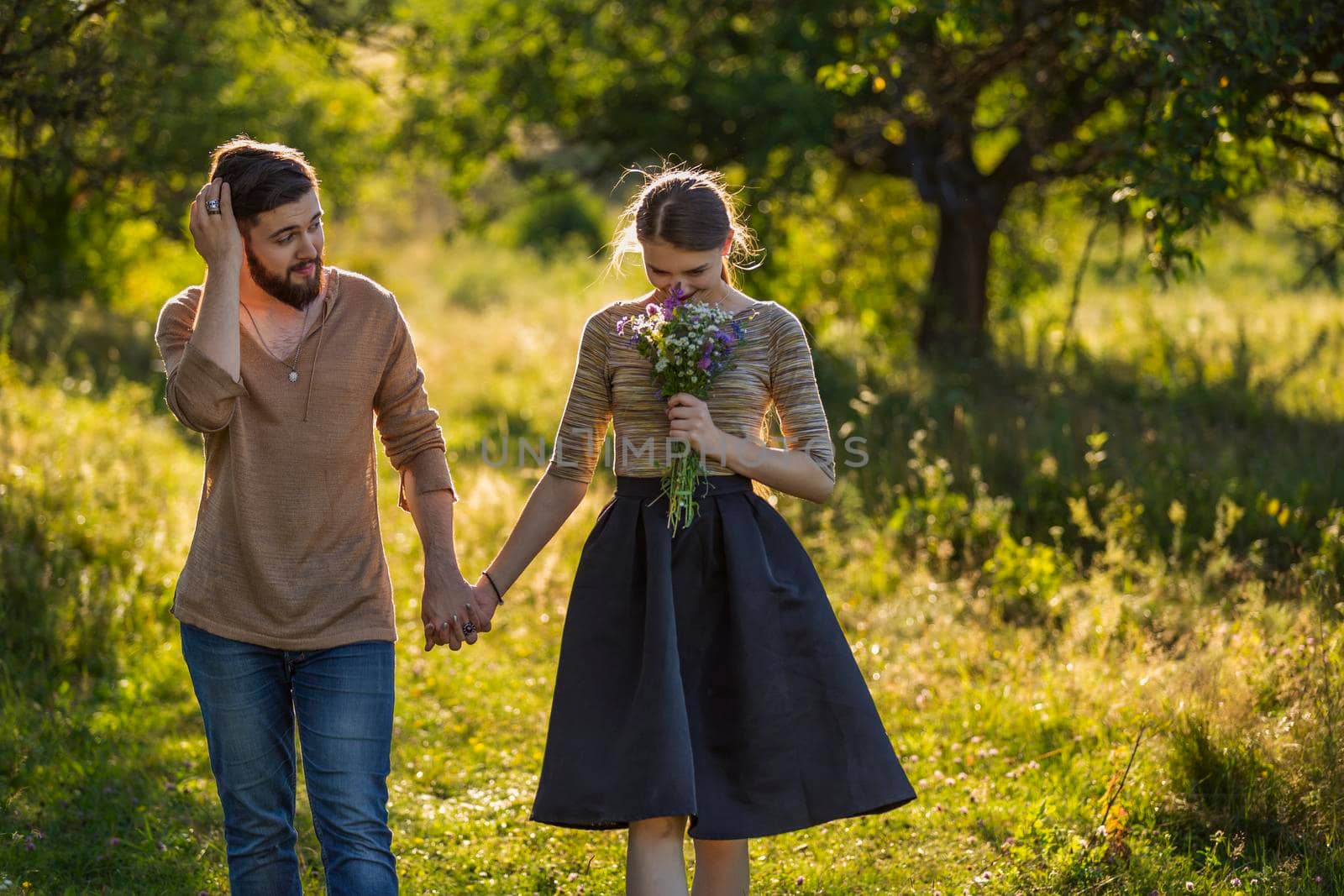 happy young couple walking in nature