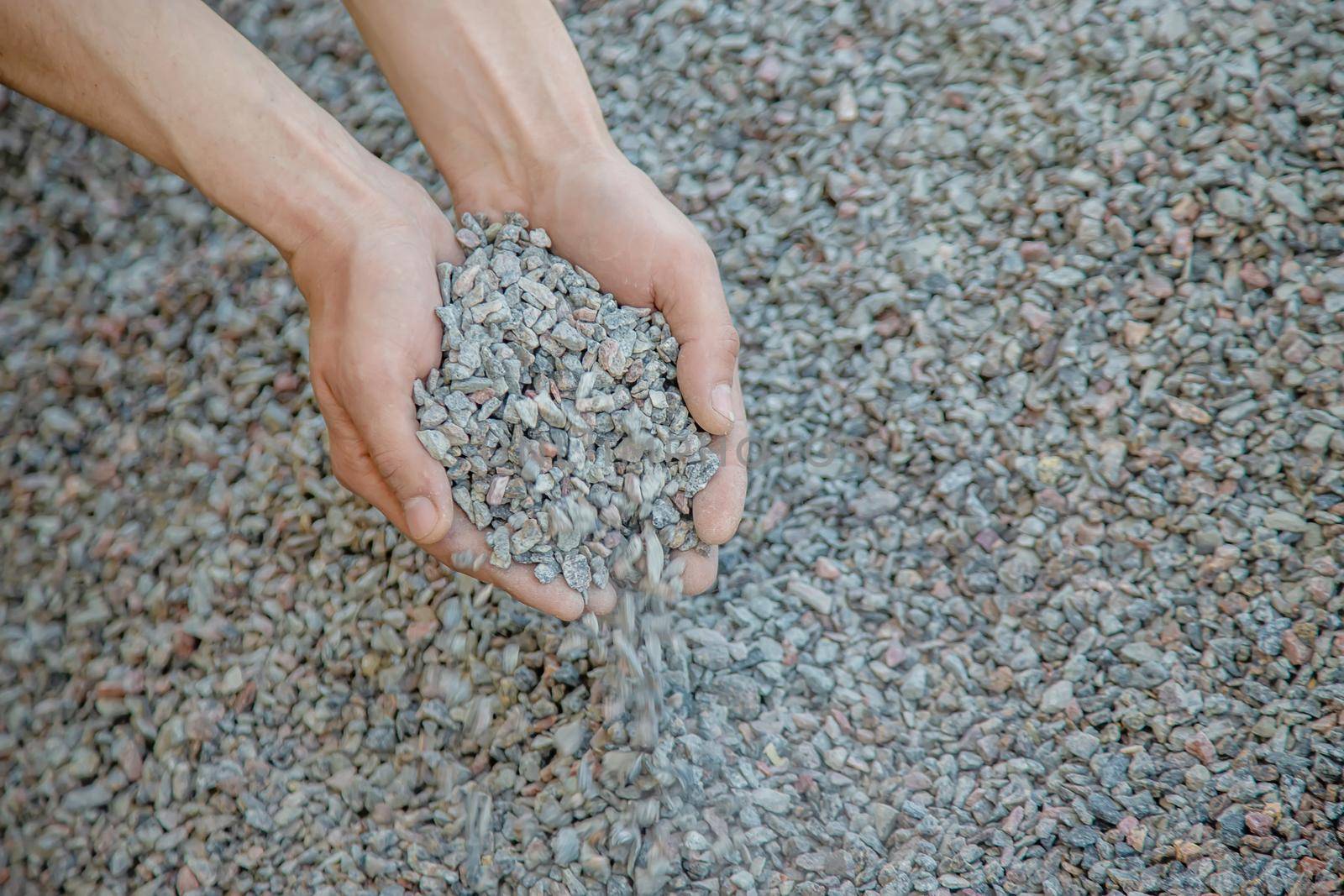 Man holding small rubble in his hands