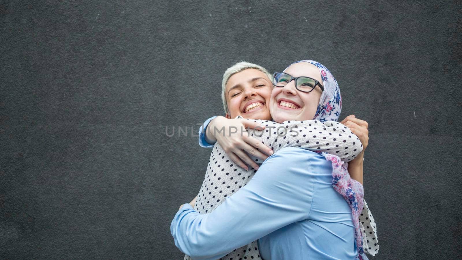 friends sharing hug with black background