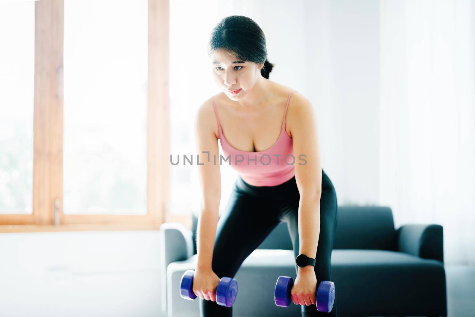 stress relief, , breathing exercises, meditation, portrait of Asian healthy woman lifting weights to strengthen her muscles after work