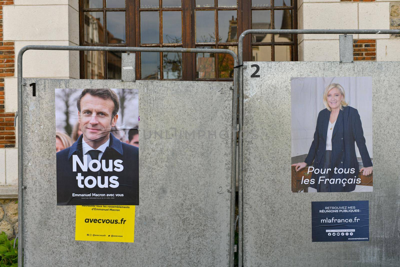 PARIS, FRANCE - APRIL 21, 2022 : The banners with candidates for President elections