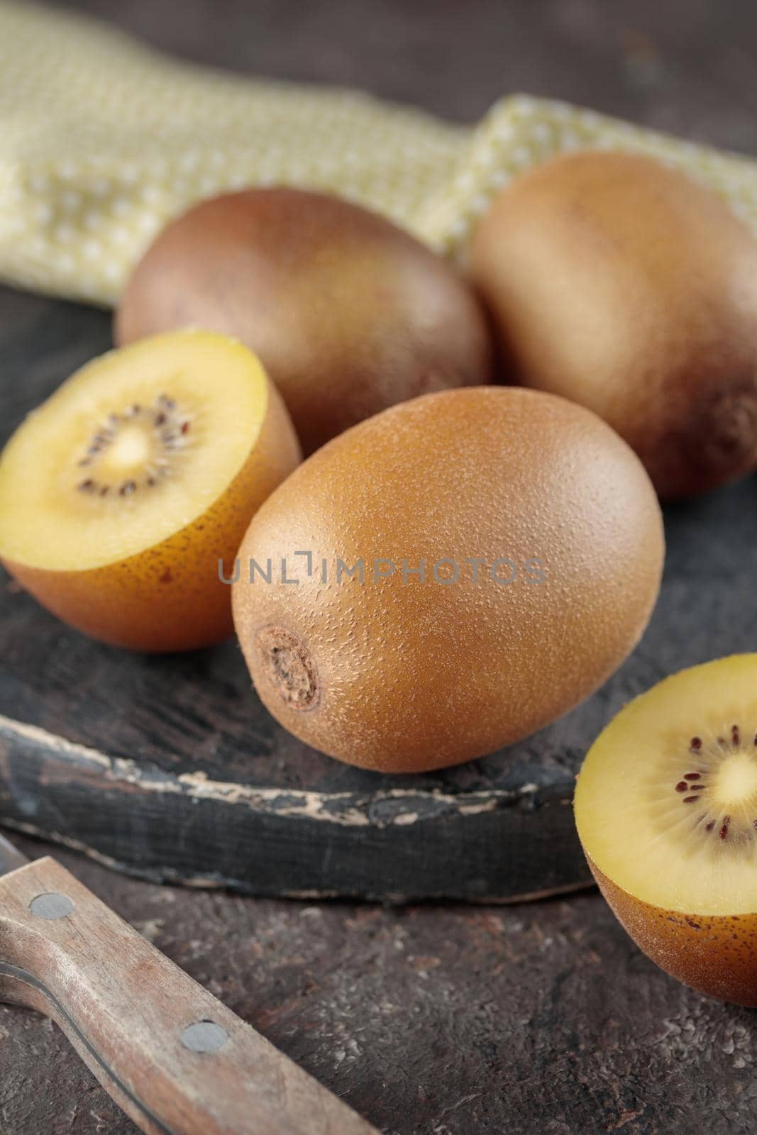 Kiwi on a black wooden board on a dark background