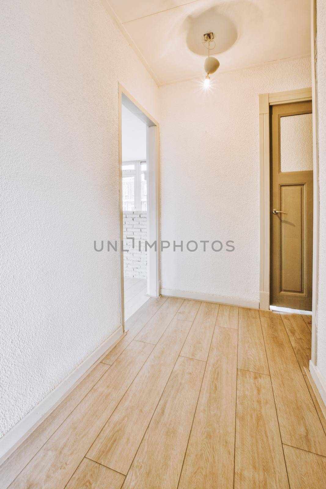Interior of contemporary flat in minimal style with spacious hallway with white walls