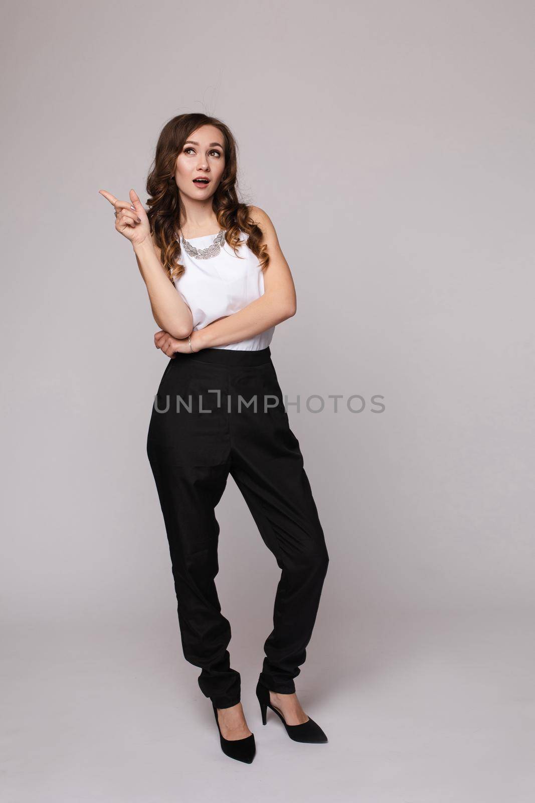 Young businesswoman thinking seriously and posing at camera. by StudioLucky