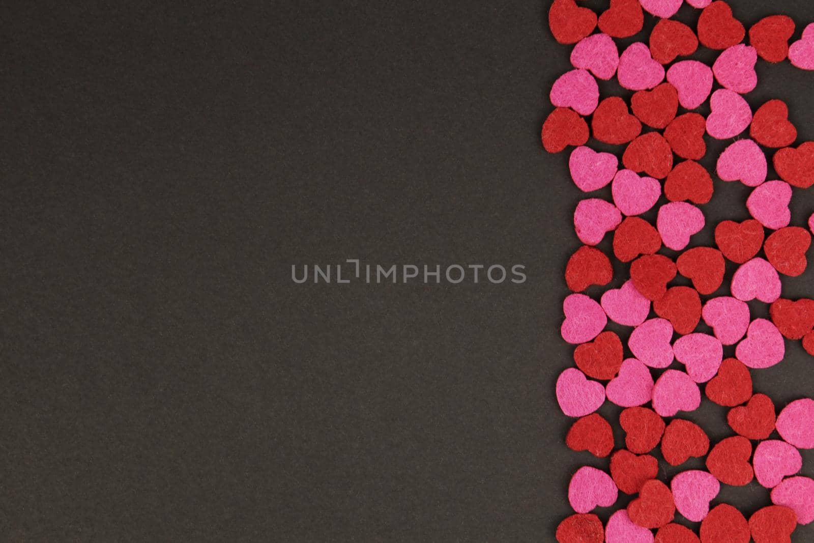 Hearts abstract background in red pink colors, on black texture - Happy Valentine's Day - Hearts Love pattern.