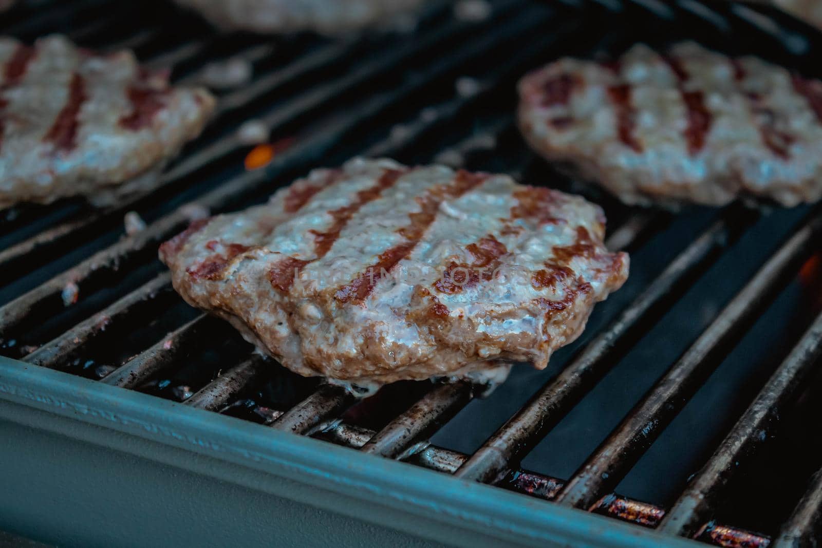 Smoky hamburger meat grilling for burgers. BBQ Grilled Burgers Patties. by JuliaDorian