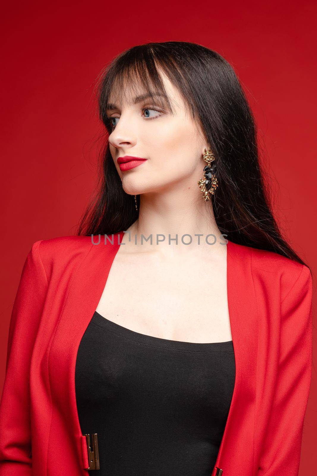 Young brunette model in red costume posing near balloons. by StudioLucky