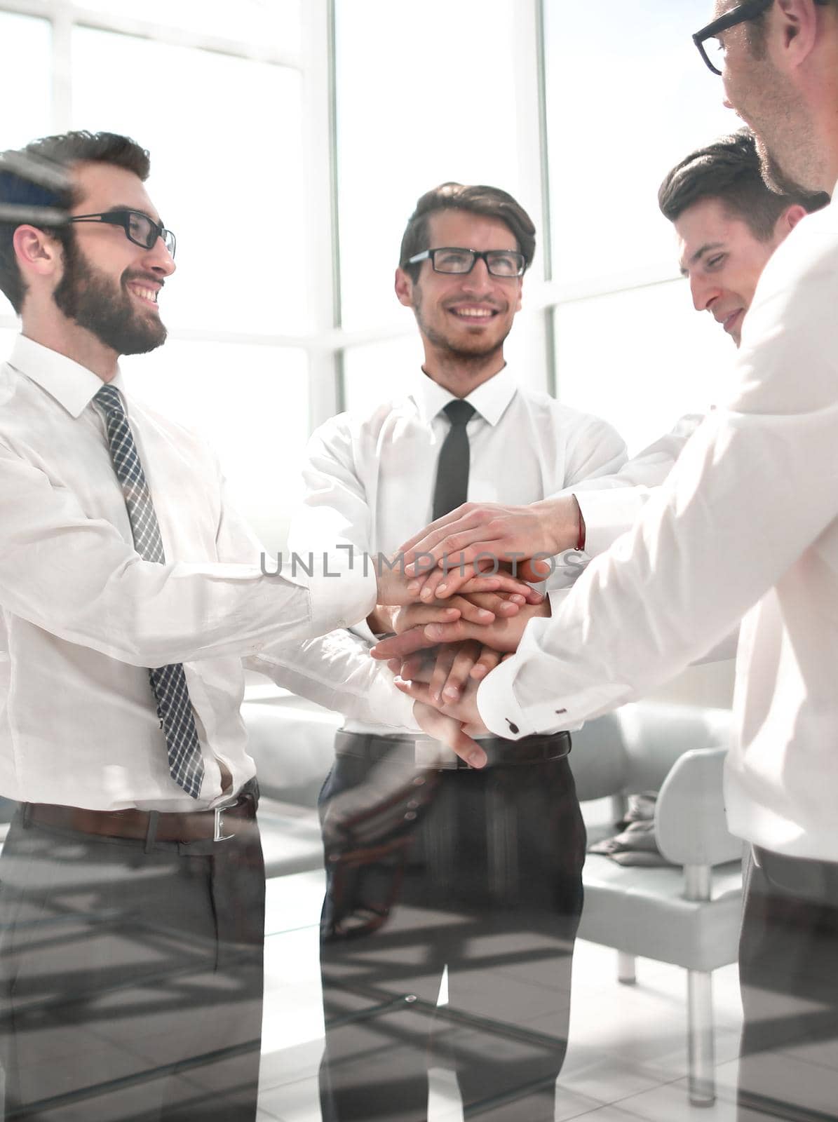 business colleagues folded their hands together.the concept of teamwork