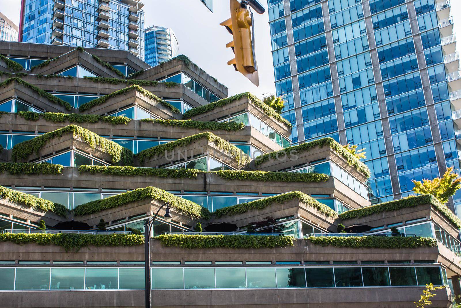 Vancouver, BC Canada - Septembre 2, 2020: green plant surrounded building. Evergreen building in the Coal Harbour area of downtown Vancouver. by JuliaDorian