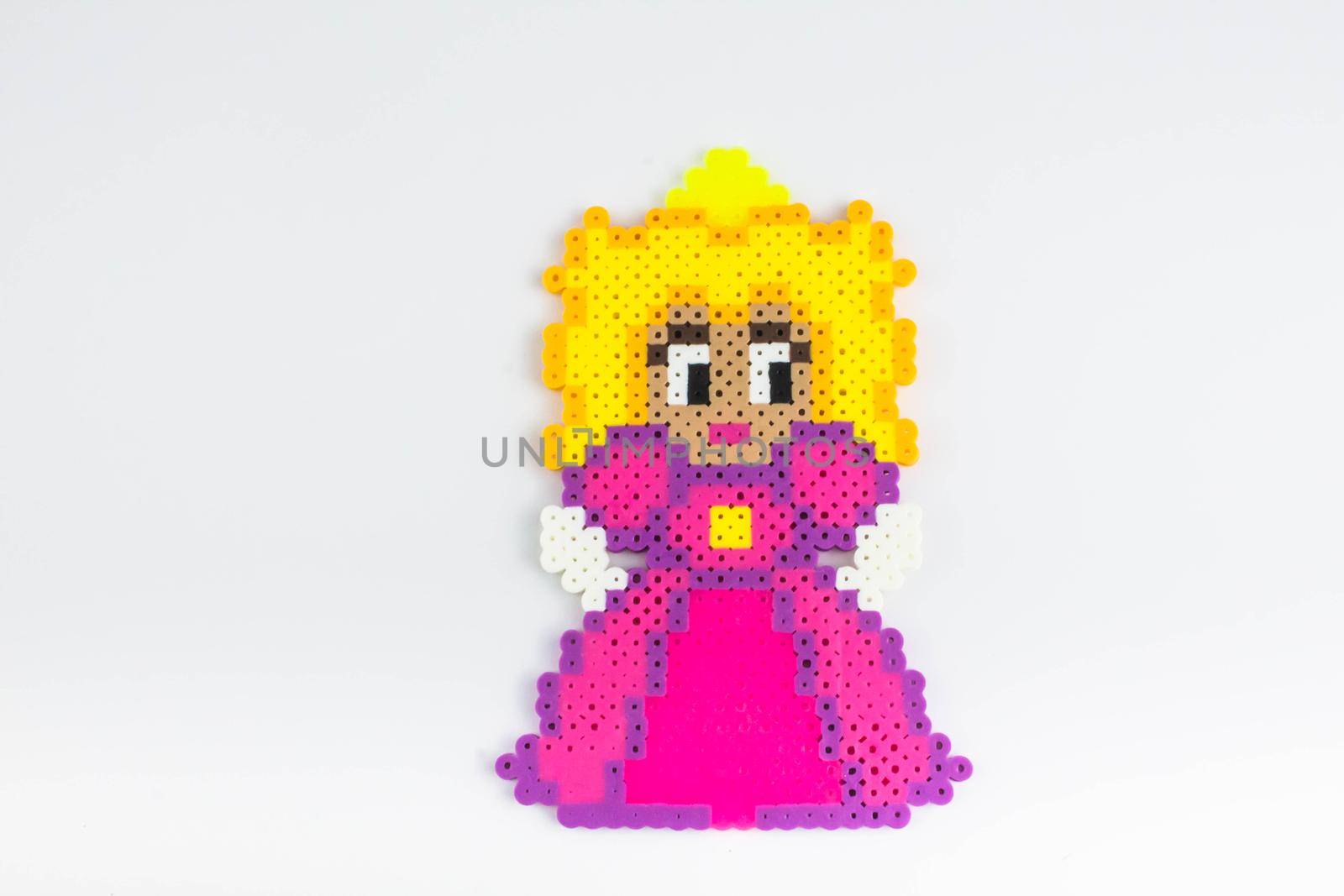 Perler bead princess in a pink dress. Perler bead doll in a pink dress.White isolated background. by JuliaDorian