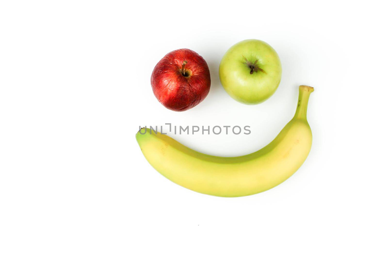 banana and apples smiley on white fashion background with space for text.