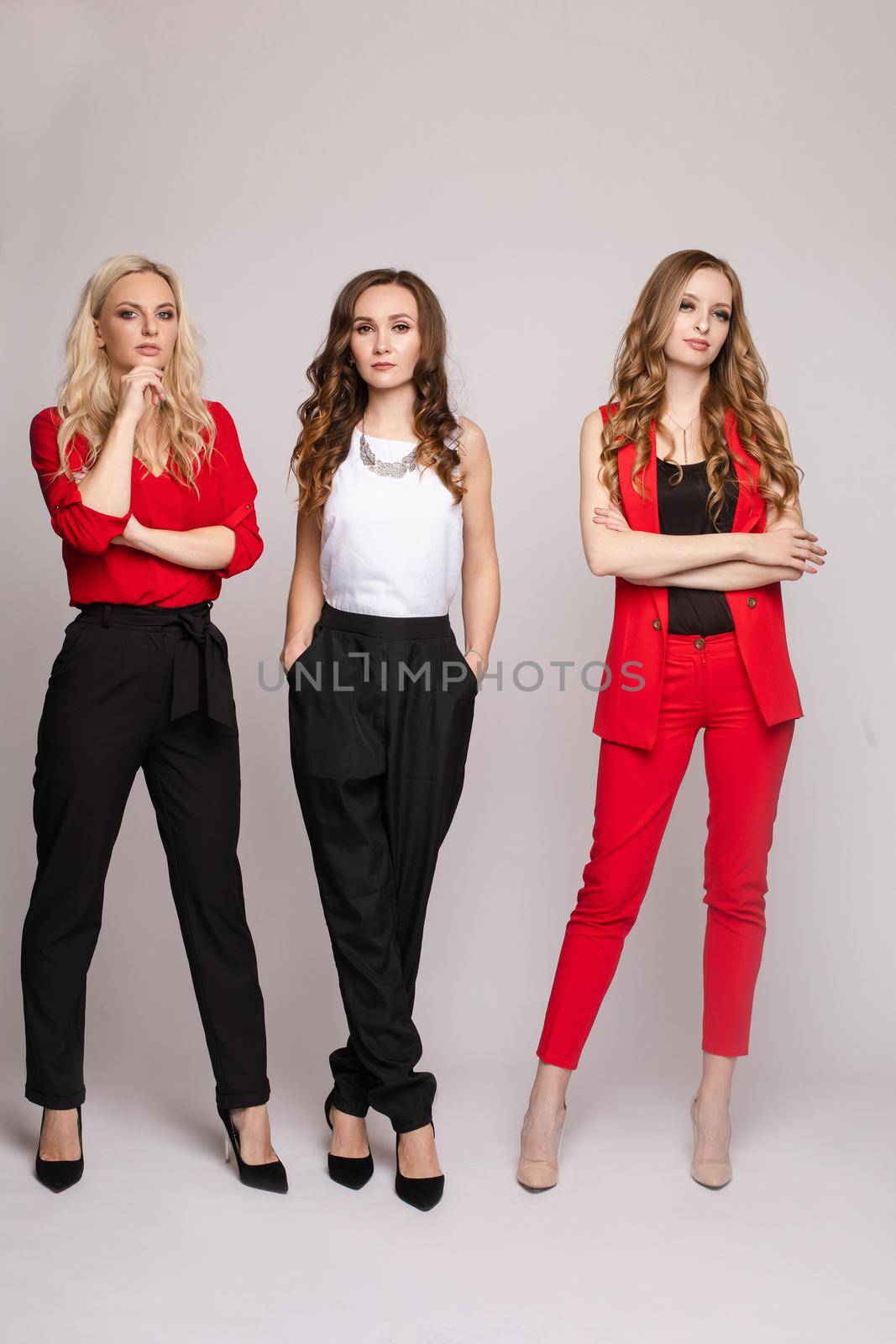 Three gorgeous elegant young women in casual clothes