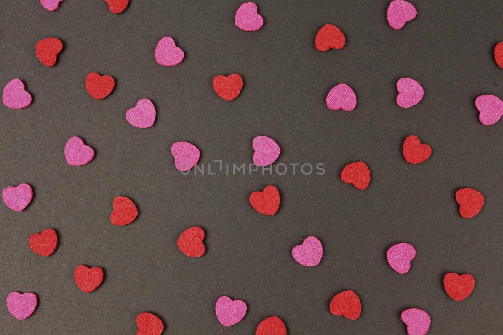 Hearts abstract background in red pink colors, on black texture - Happy Valentine's Day - Hearts Love pattern.