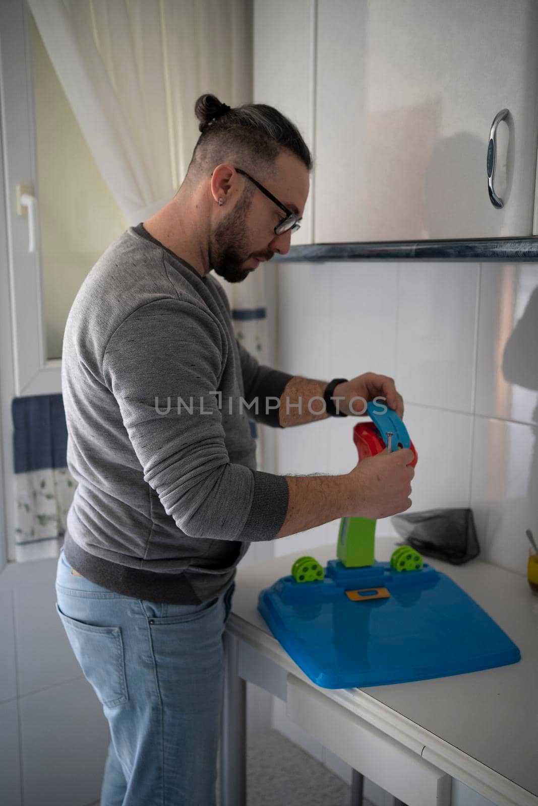 father assembling toy to give it to his daughter. image projection toy