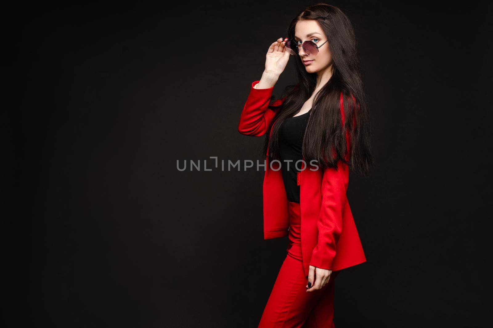 View from side of stylish brunette wearing glasses by StudioLucky