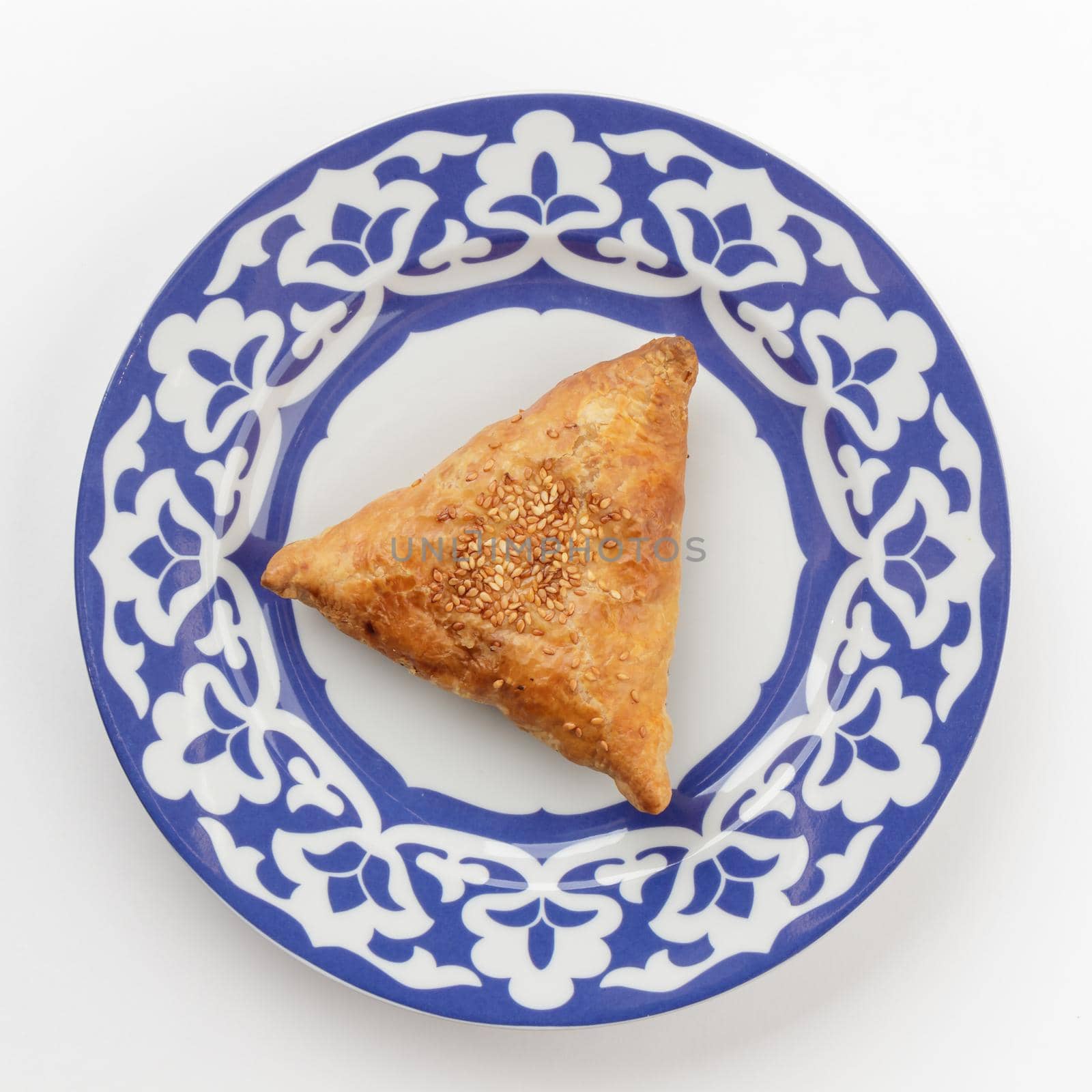 Samsa - oriental Uzbek cuisine dish in traditional plate top view