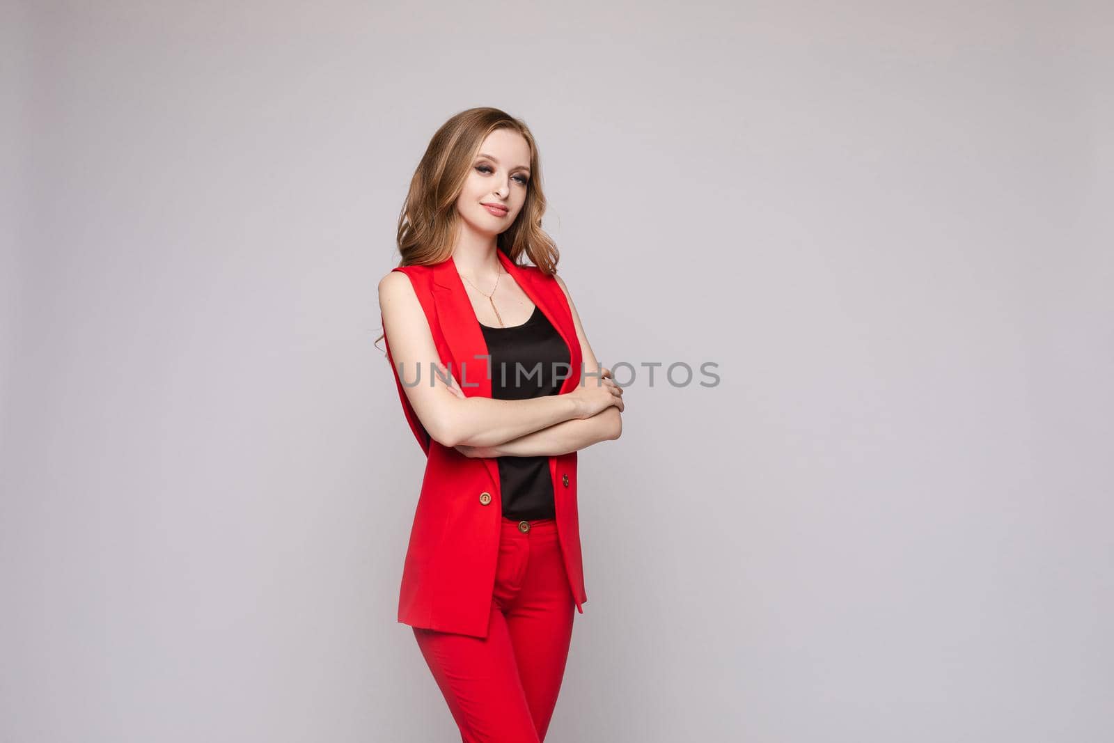 Young businesswoman thinking seriously and posing at camera. by StudioLucky