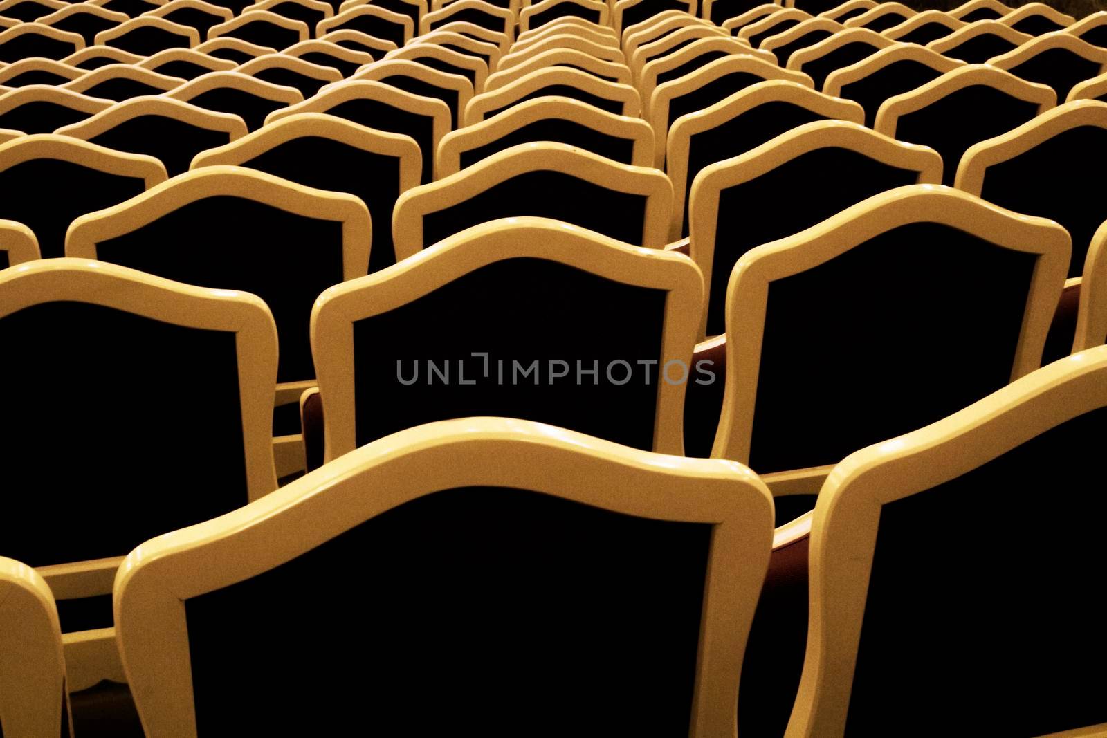 Empty and antique seats aligned and forming a pattern in an opera