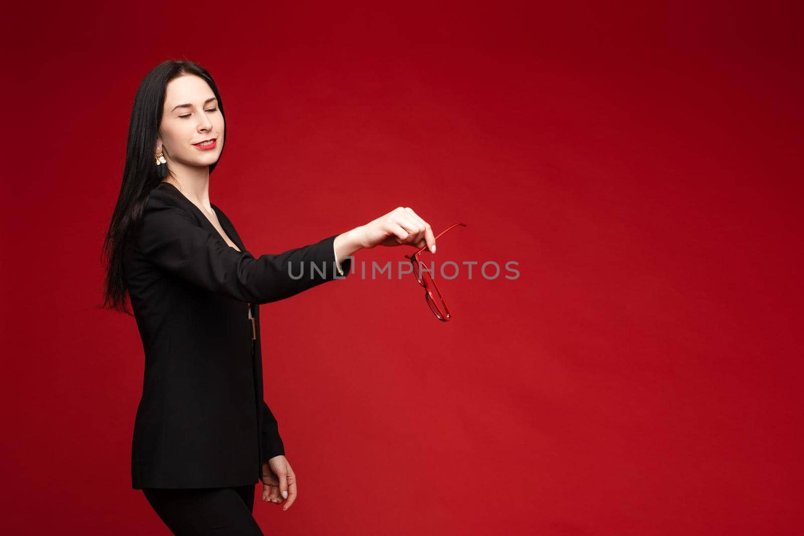 Young businesswoman thinking seriously and posing at camera. by StudioLucky
