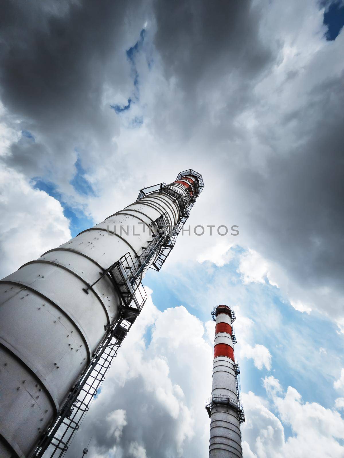 Two chimneys of the power plant diagonally against the sky