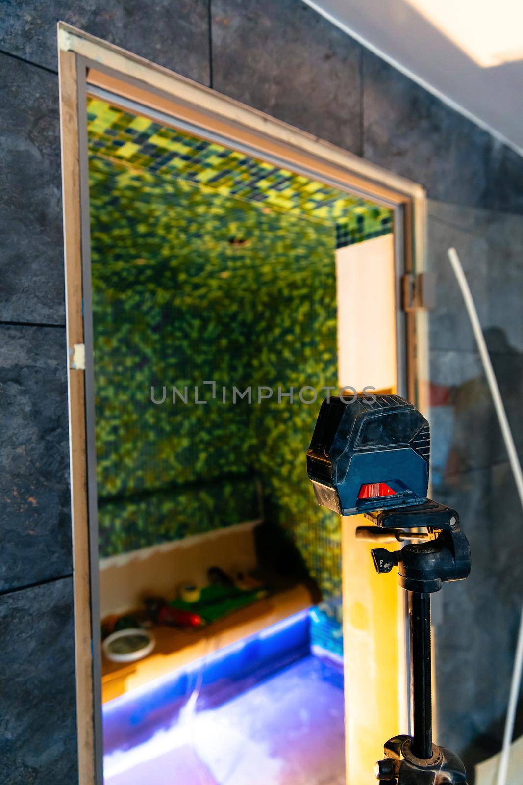 Laser level in applying mosaic tiles on walls by RecCameraStock