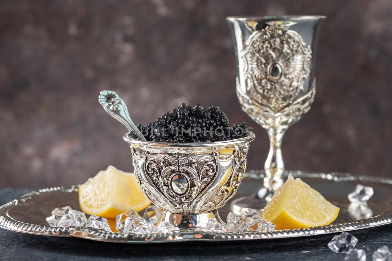 Black Caviar in a silver bowl on a dark background