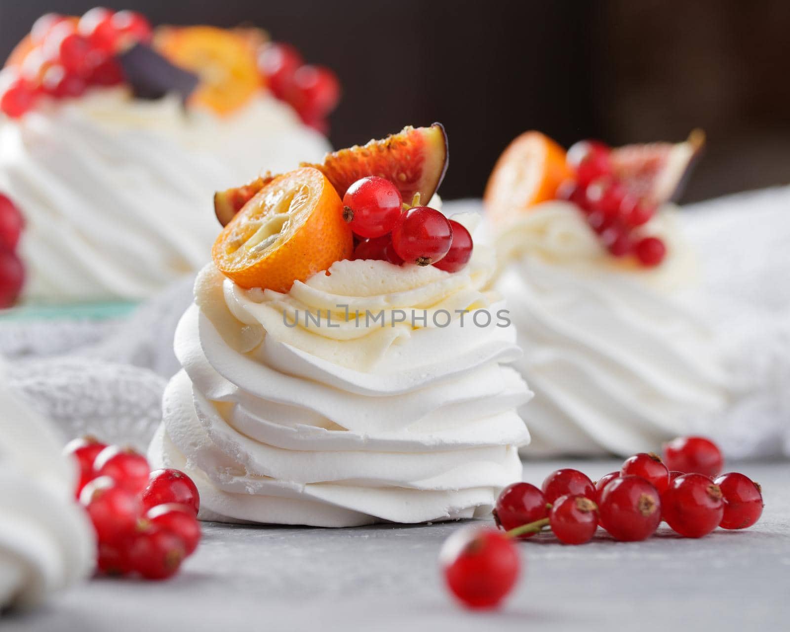 Pavlova dessert with berries on a gray background