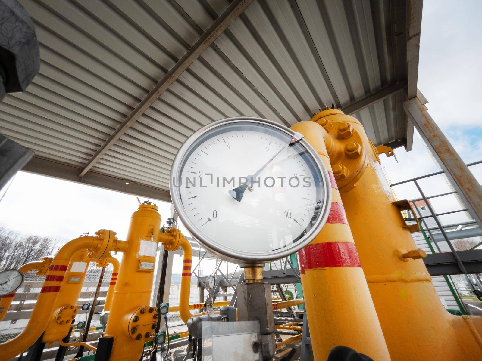 Pressure gauge measuring the pressure on the yellow natural gas pipeline for the supply of power plants