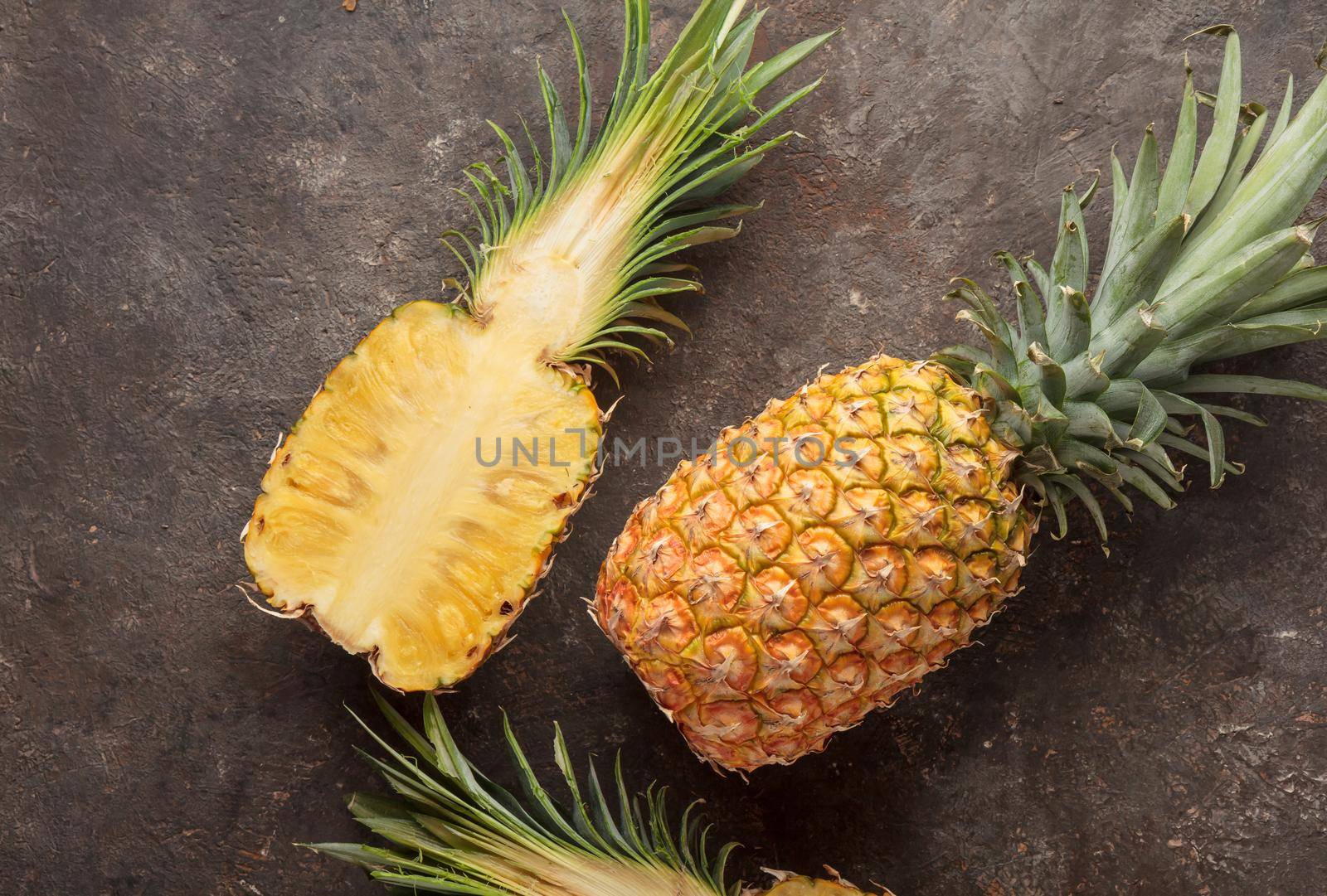 Ripe pineapple on the dark table