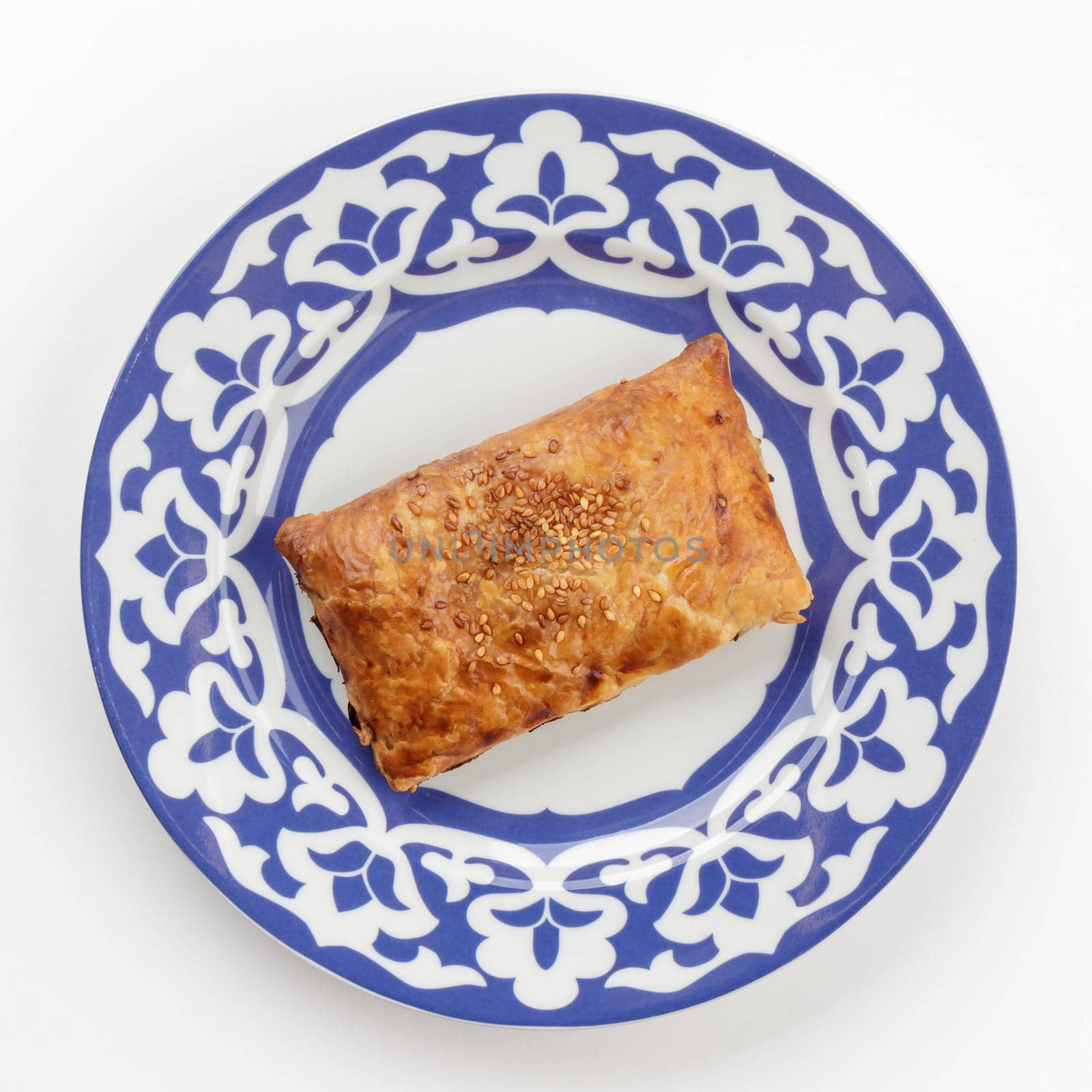 Samsa - oriental Uzbek cuisine dish in traditional plate top view