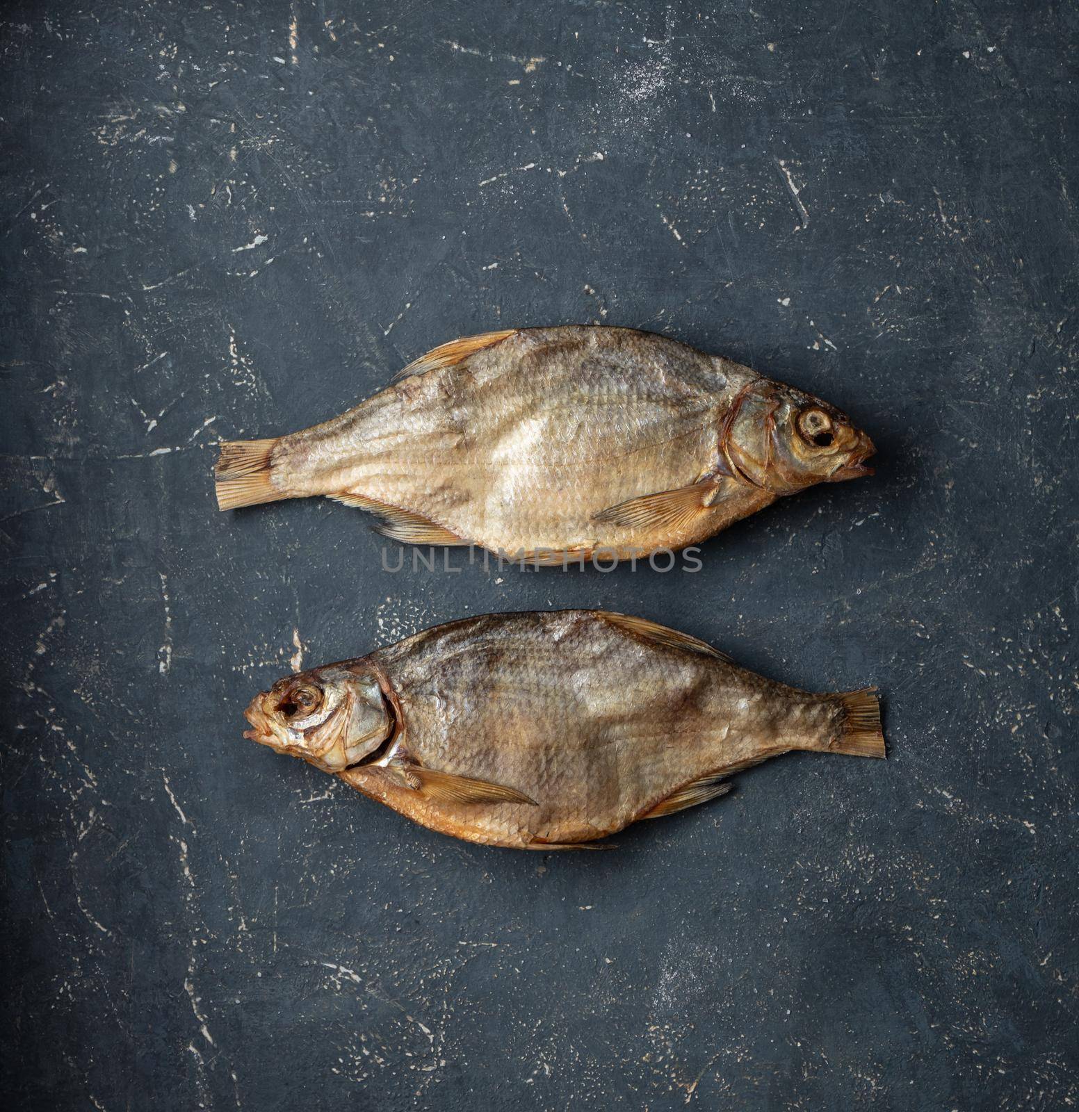 Dried caspian roach fish on a blue background