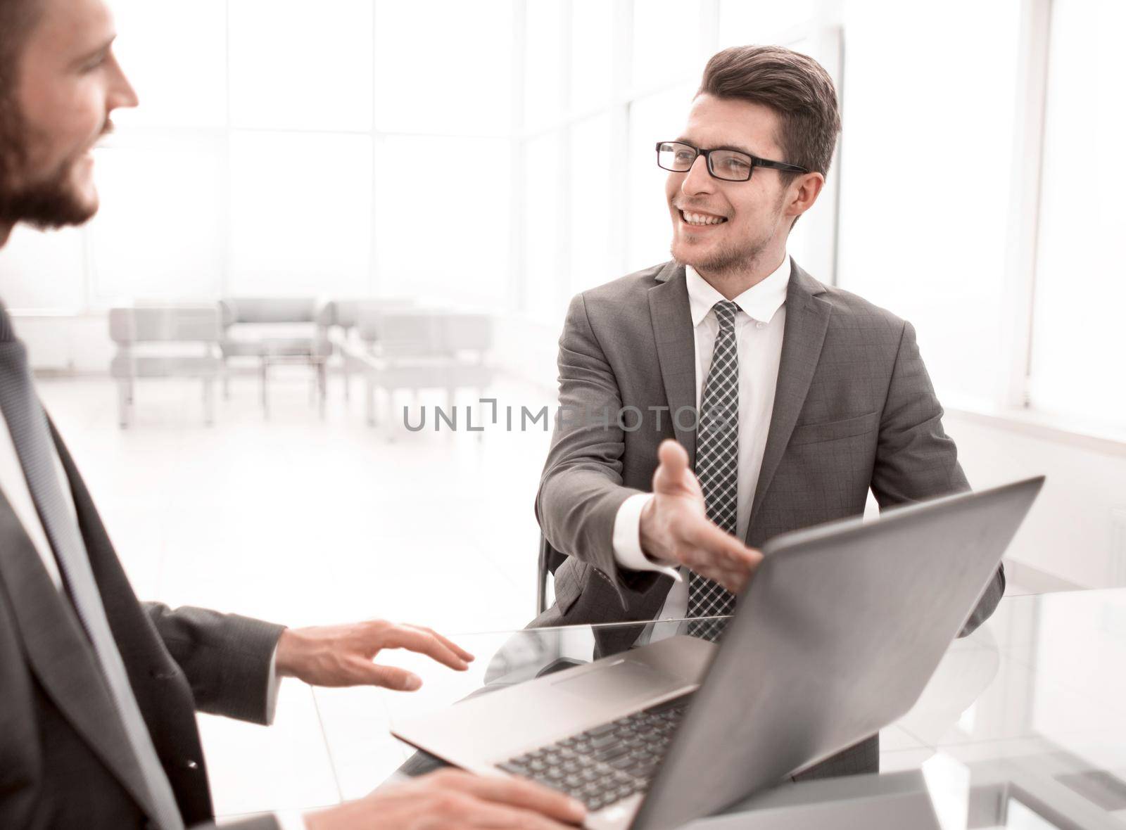 close up.business partners discuss information sitting at the office table.people and technology