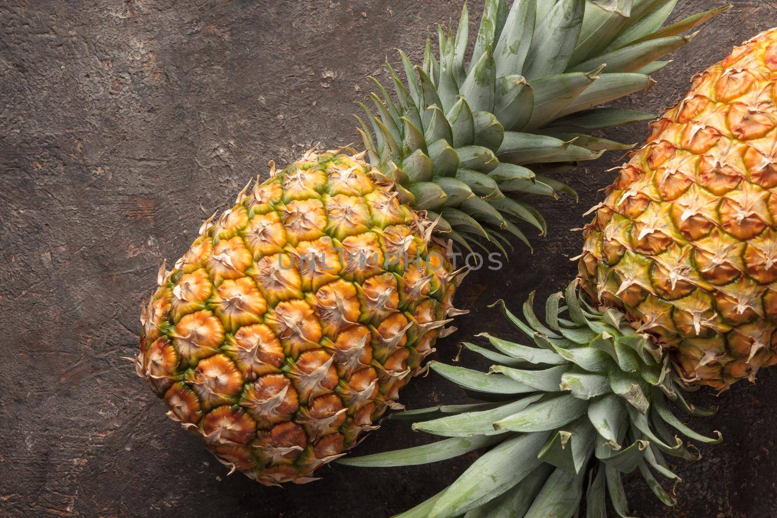 Ripe pineapple on the dark table