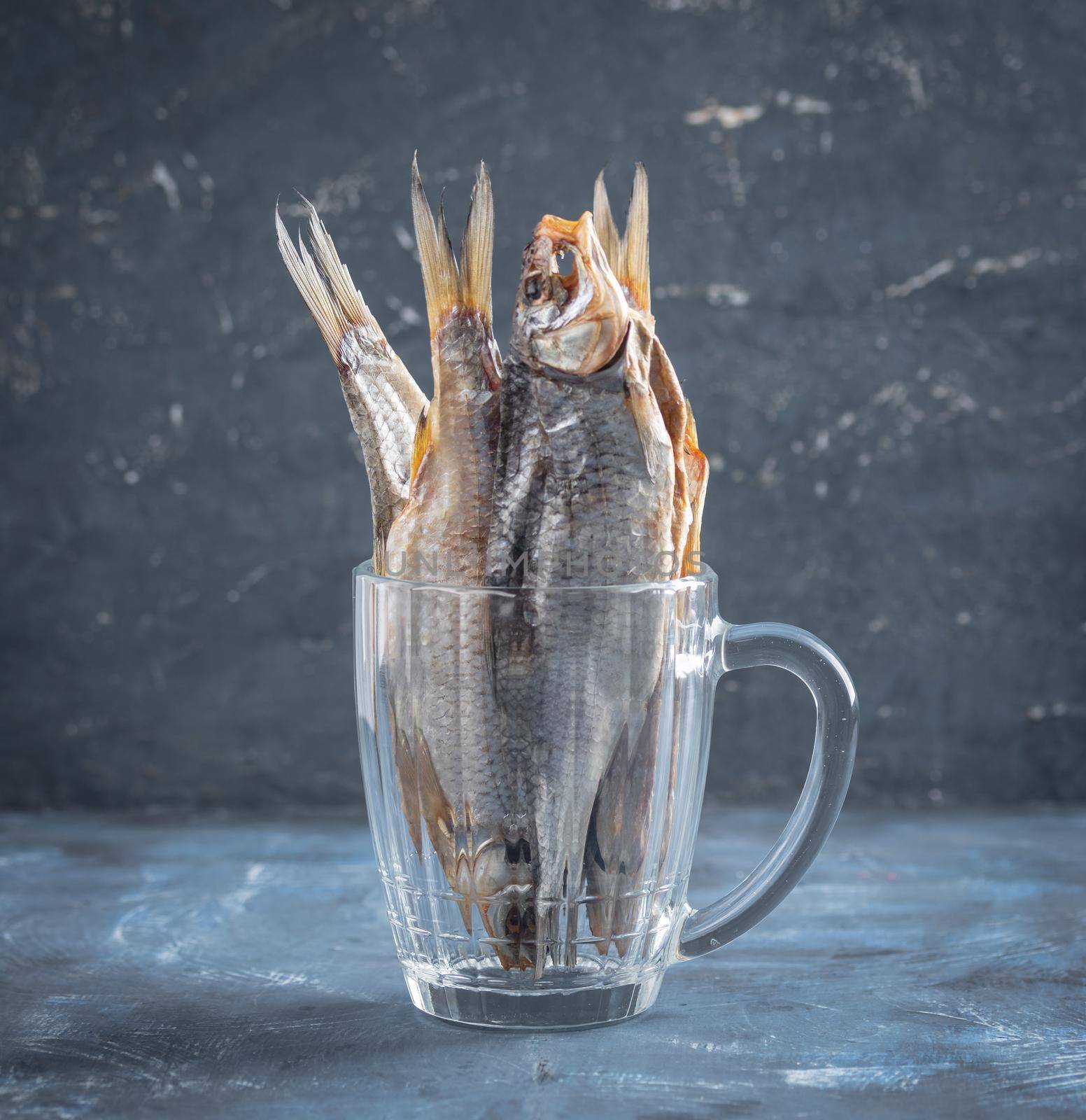 Dried caspian roach fish on a blue background