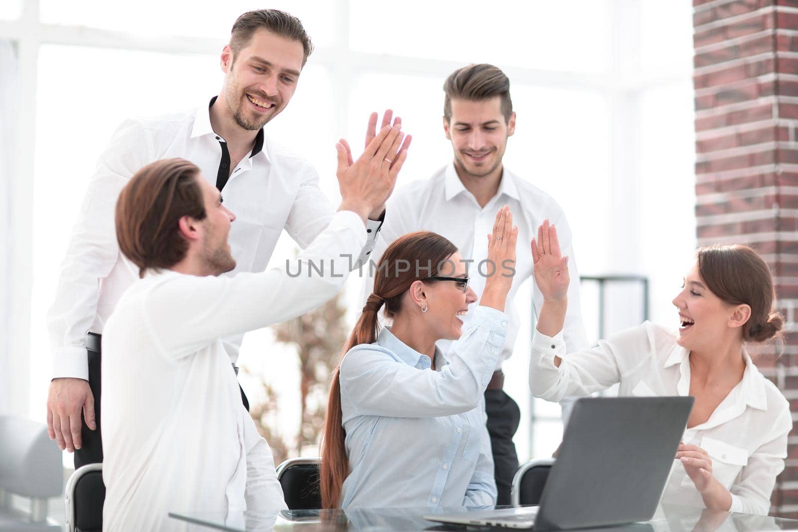 business team starts a business project and giving each other a high five.concept of success