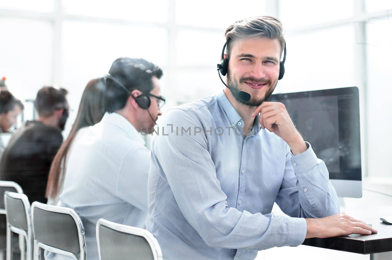 operator call center in the workplace in a bright office .photo with copy space