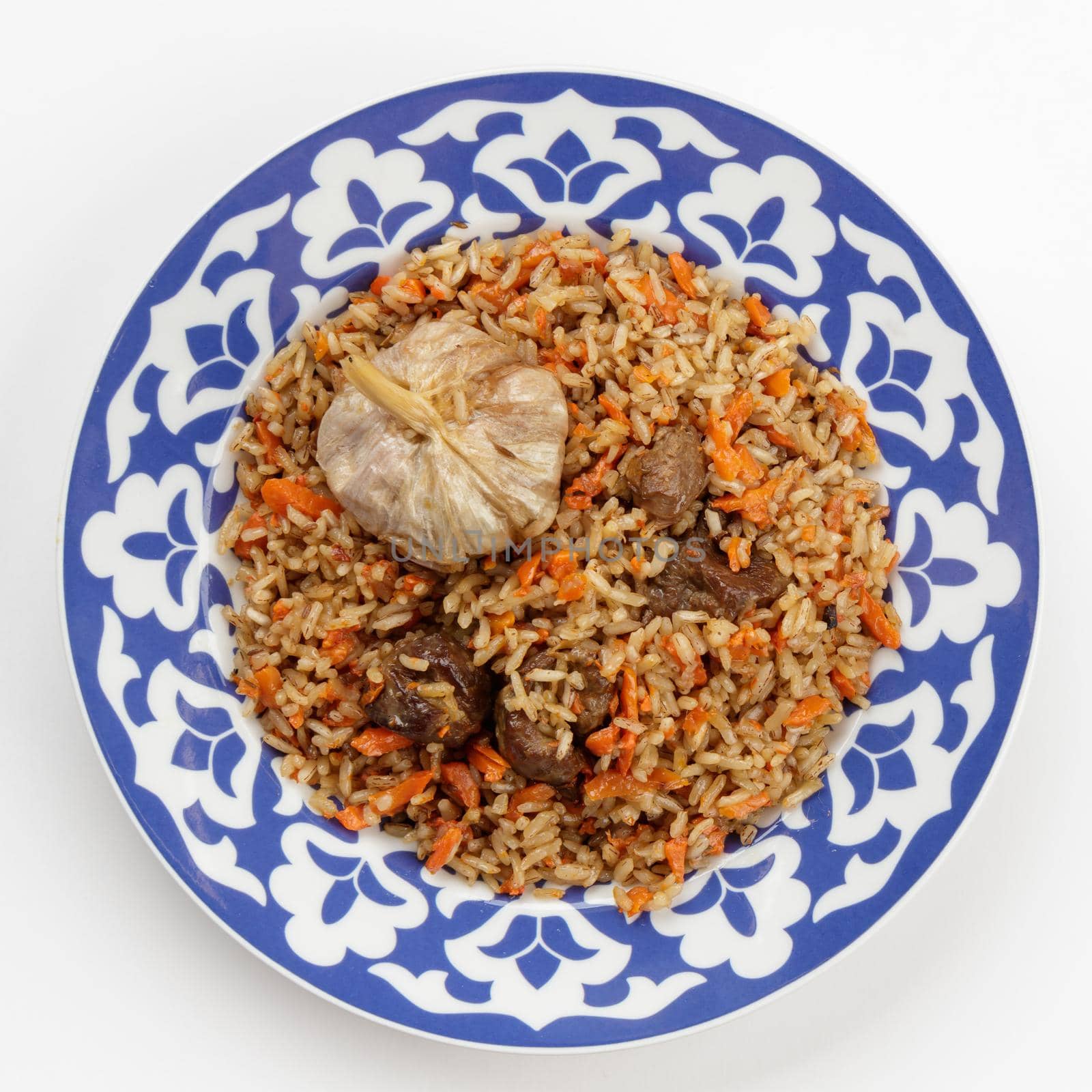 Oriental Uzbek cuisine dish in traditional plate