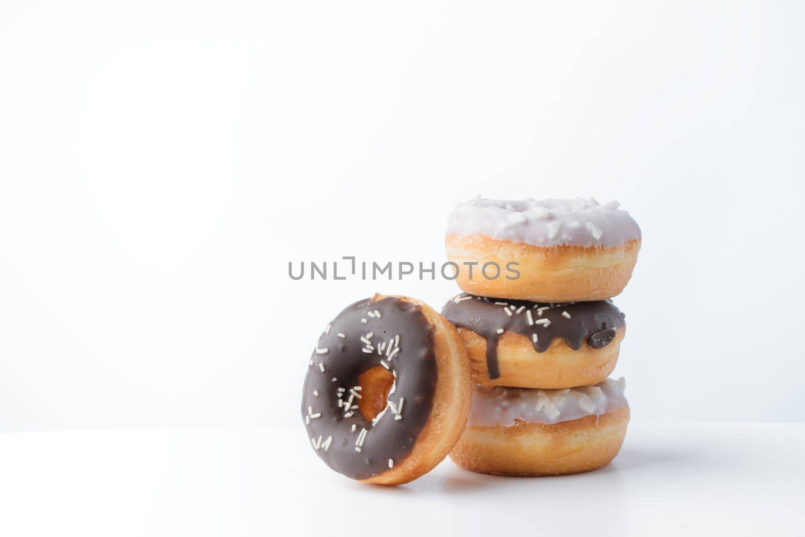 Donuts with dark and white chocolate on a white background