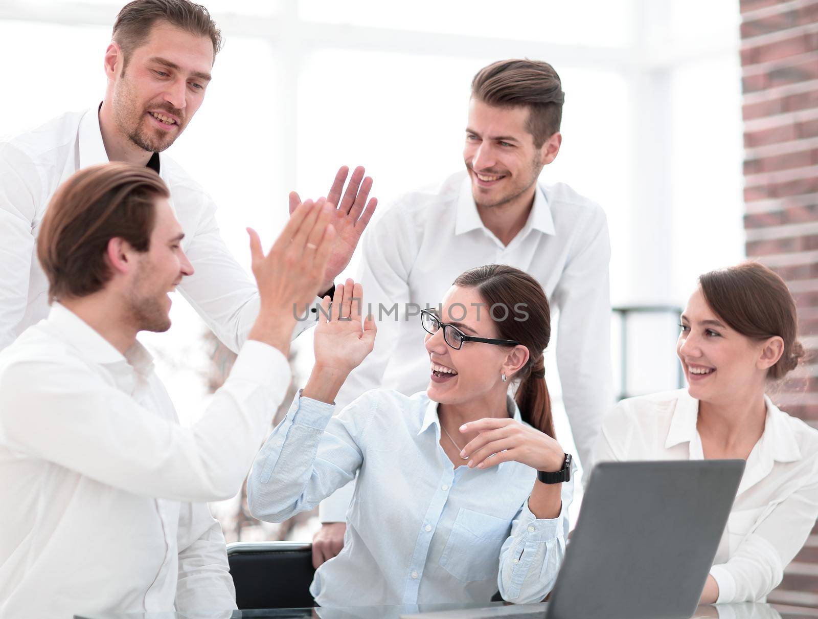 business team giving each other high five by asdf