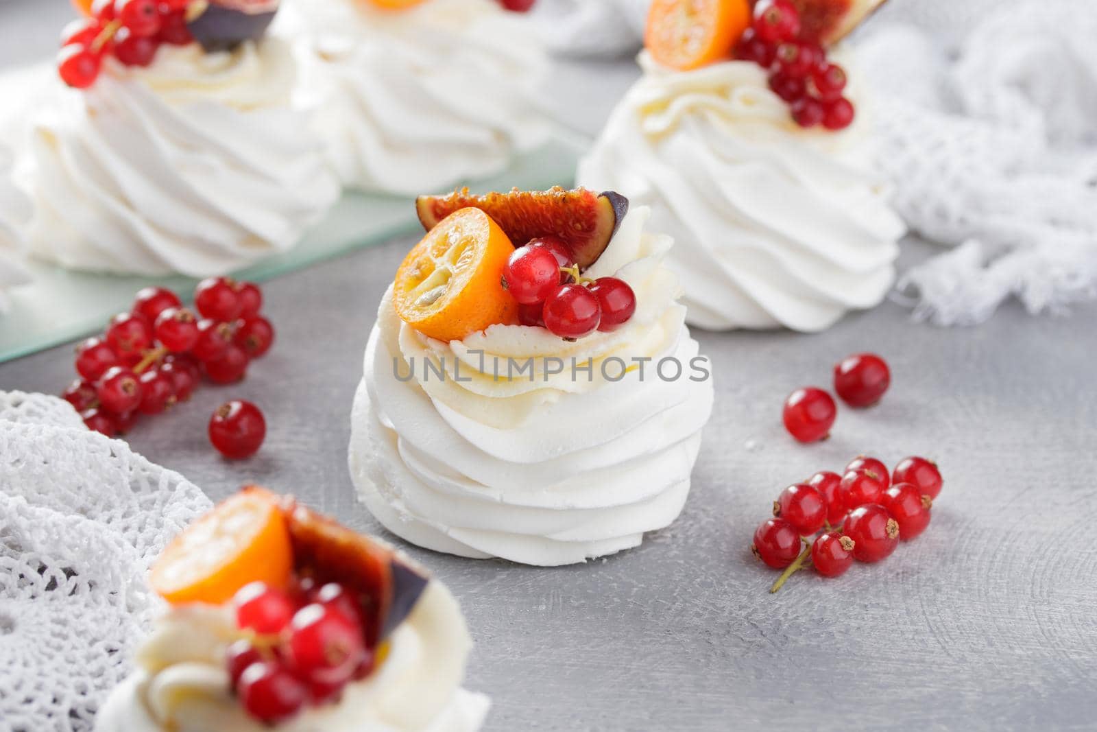 Pavlova dessert with berries on a gray background