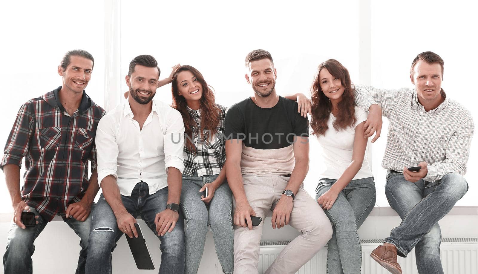 successful young people sitting on the windowsill.photo with copy space