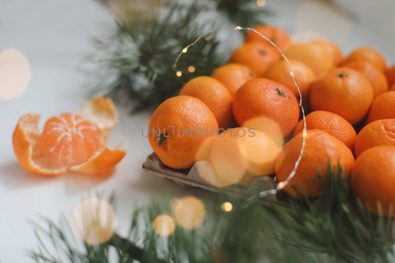 Christmas background with fir tree branches and tangerines. Merry Christmas and Happy New Year Greeting Card. Copy space. Top view. High quality photo