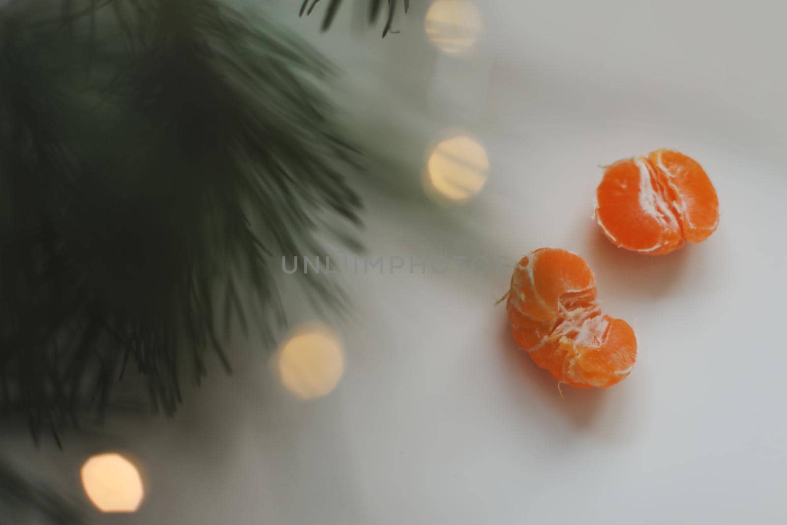 Christmas background with fir tree branches and tangerines. Merry Christmas and Happy New Year Greeting Card. Copy space. Top view. High quality photo