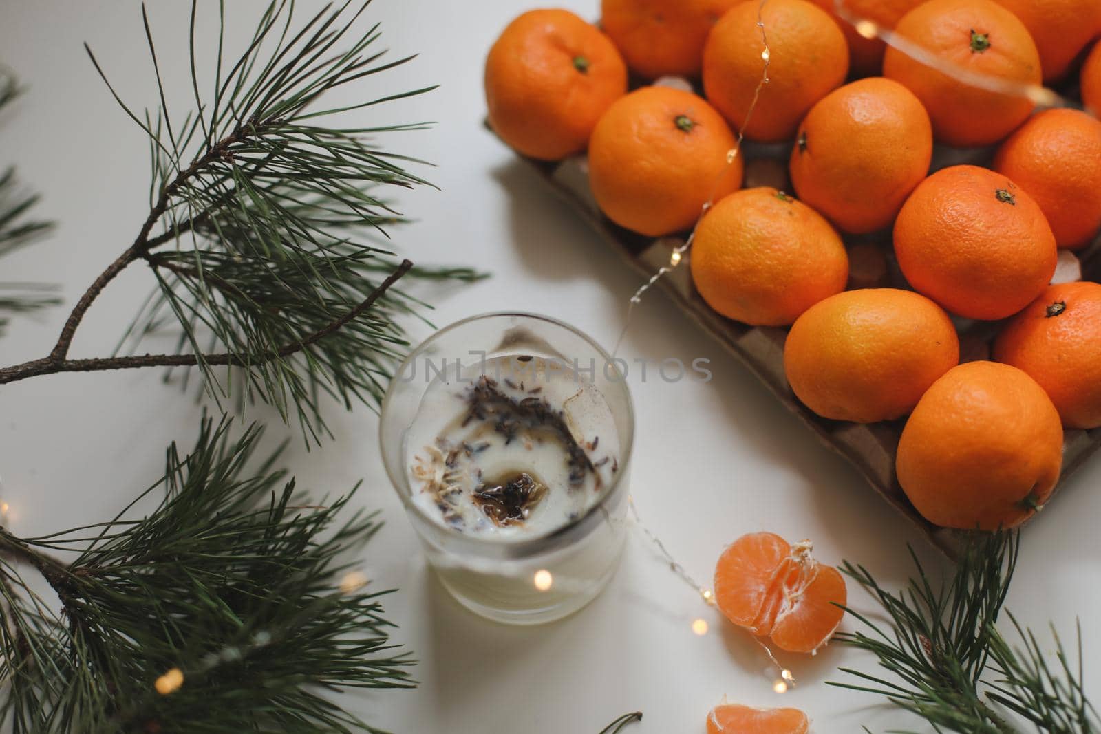 Christmas background with fir tree branches and tangerines. Merry Christmas and Happy New Year Greeting Card. Copy space. Top view. High quality photo
